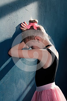 Young ballerina crying in despair due to failures in the classroom at the ballet