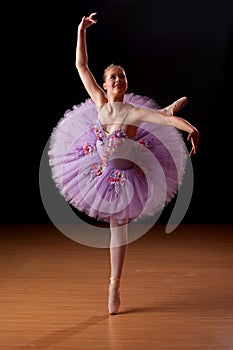 Young ballerina in studio practising