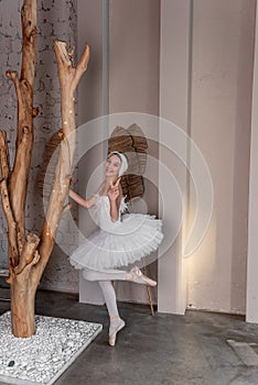 Young ballerina in white tutu with joyful smile fooling around, captures the whimsy of dance