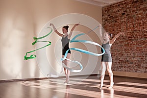 Young ballerinas in motion. Rhythmic gymnastics