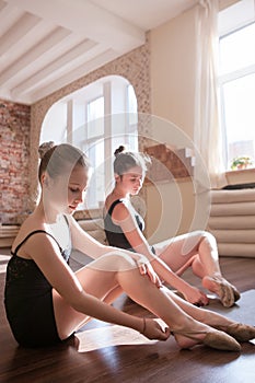 Young ballerinas. Pensive ladies in class