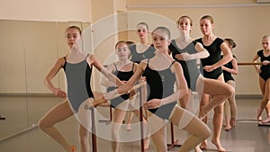 Young ballerinas rehearse a choreographic exercise at a ballet school.