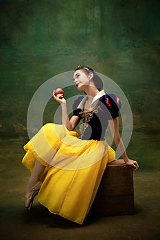 Young ballet dancer as a Snow White with poisoned apple in forest