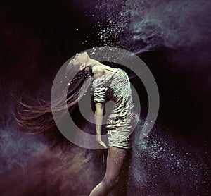 Young ballet dancer dancing with the dust