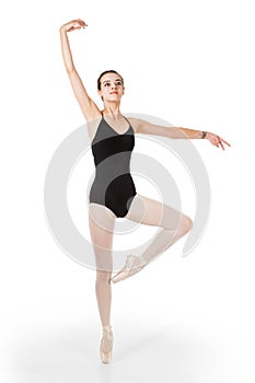 Young ballet dancer in passe en pointe