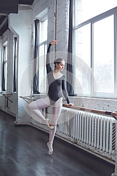 Young ballet dancer practice movement in studio active lifestyle