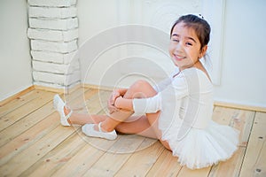 Young ballet dancer preparing for lesson