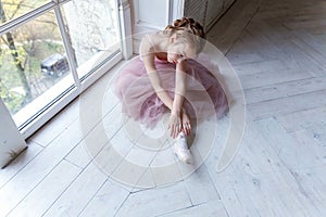 Young ballet-dancer sitting on the floor