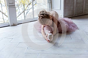 Young ballet-dancer sitting on the floor