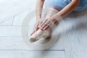 Young ballet-dancer sitting on the floor