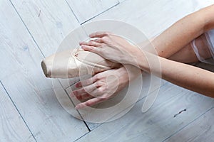 Young ballet-dancer sitting on the floor