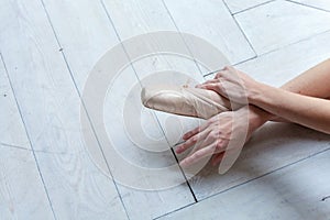 Young ballet-dancer sitting on the floor