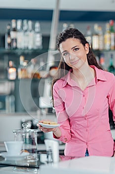 Young barista serving cookies