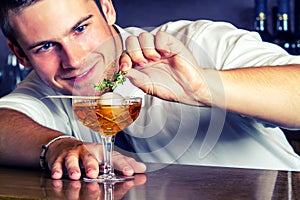 Young barkeeper preparing drink