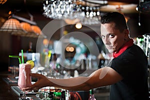 Young bartender with cocktail photo