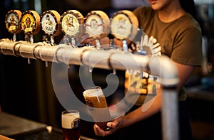 Young bartender pouring Berg River beer from a beer tap into a glass