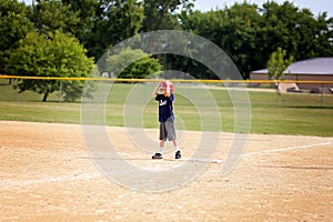 Young Baseball Player Child Standing on First Base Waiting to Ru
