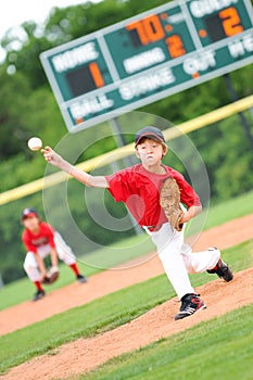 Young baseball player pitching the ball