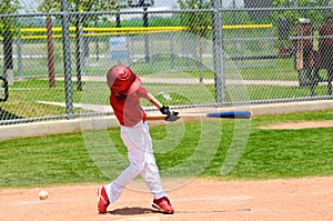 Young baseball player swinging bat