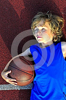 Young basketball player holding a ball