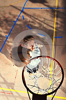 Young basketball player playing with energy