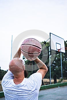 Young basketball player shooting a triple