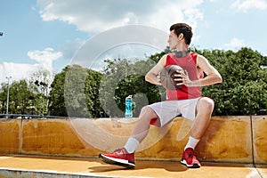 A young basketball player sitting on