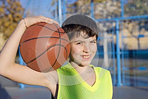 Young basketball player standing on the court wearing a yellow s