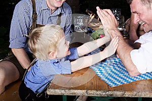 Young bavarian boy with father at beergarden