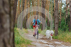 Young beaming woman enjoying her weekend with husky