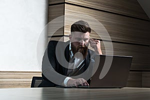 Young beard businessman late night work in office