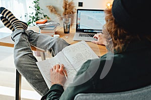 Young beard college student sit by the work table and prepare to pass exam to university