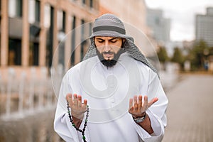 Young bearded arabian guy doing namaz