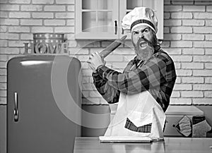 Young bearded chef angry or banging on someone on kitchen.