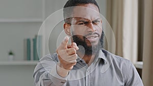 Young bearded disgruntled angry African black businessman professional HR manager employer outstretch hand looking