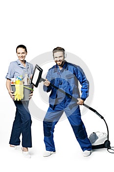 Young bearded handsome guy and a girl in a uniform of cleaners are isolated on a white background. In the hands of a bucket with