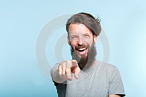 Mockery laughing grinning man point finger sneer photo