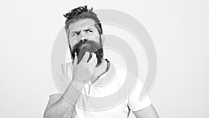 Young bearded man doubting, over white wall. Copy space. Handsome man thinking an idea. Man has own startup project idea