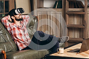 Young bearded man enjoying virtual reality glasses