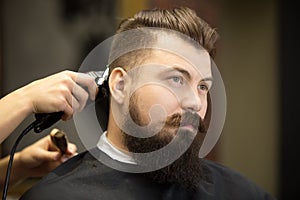 Young bearded man in hairdresser salon