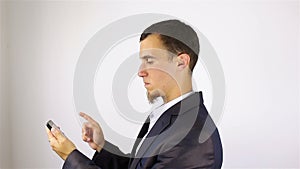 Young bearded man hands writing sms, texting on smartphone.