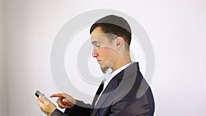 Young bearded man hands writing sms, texting on smartphone.