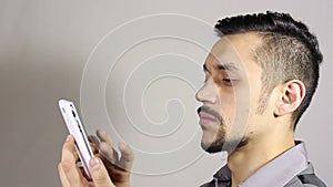 Young bearded man hands writing sms, texting on smartphone.