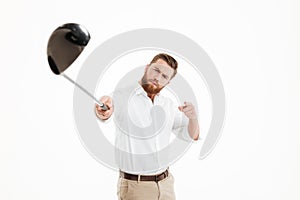 Young bearded man holding golfstick.