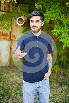 Young bearded man juggles with the coffee kettle.