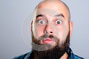 Young bearded man lokking amazed