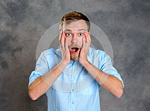 Young bearded man lokking amazed