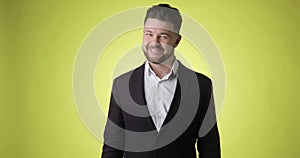 Young bearded man in office suit inhale with relieved smiling looking at camera.