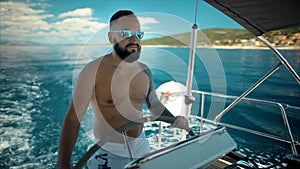 Young bearded man sailing in sea