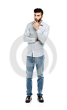 A young bearded man with a serious expression on his face isolated on white